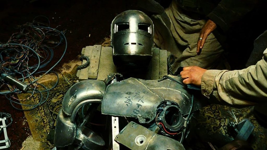 Première armure Mark I en métal forgé dans la grotte par Tony Stark et Yinsen dans le film Iron Man (2008).